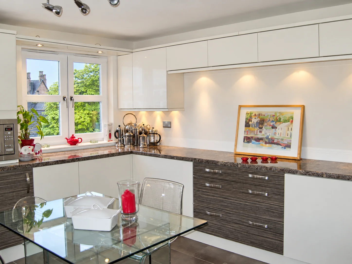 Completed white kitchen with dark worktops and dining area